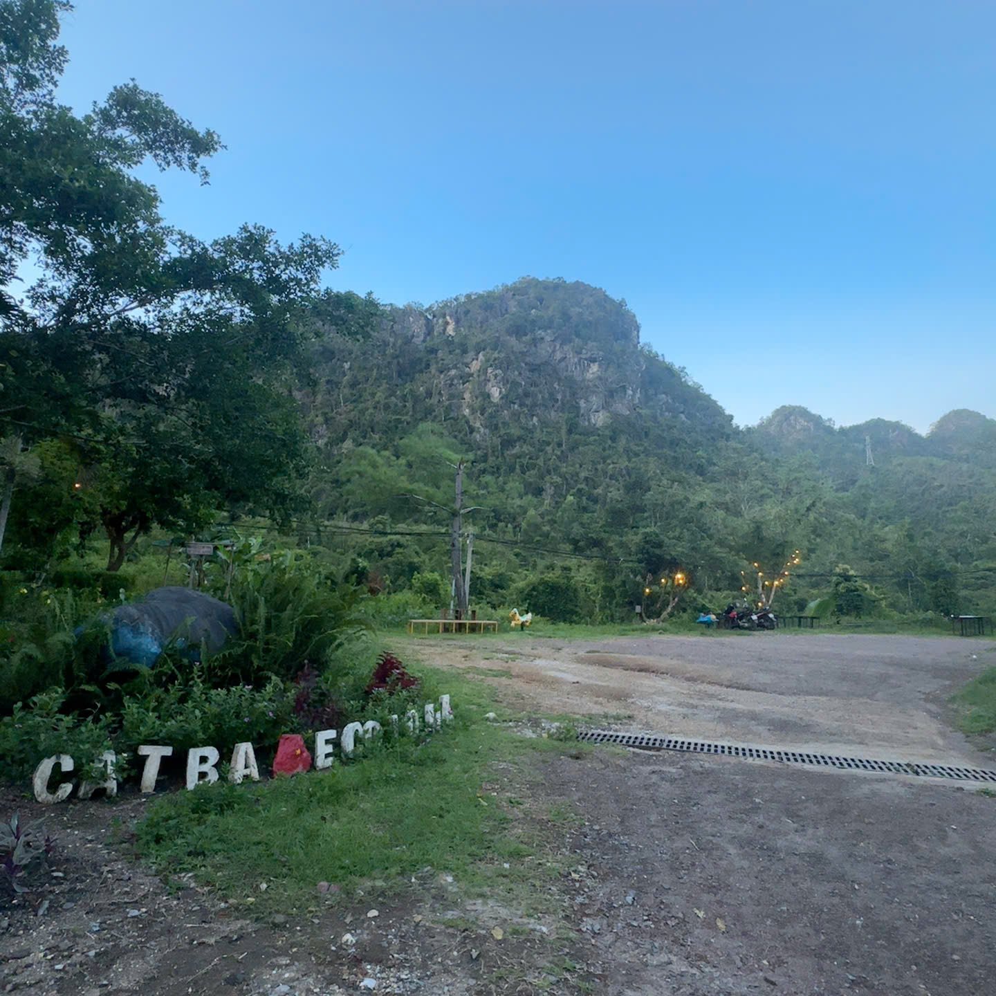 A charming wooden bungalow nestled among tropical greenery at the Cat Ba Eco Lodge.